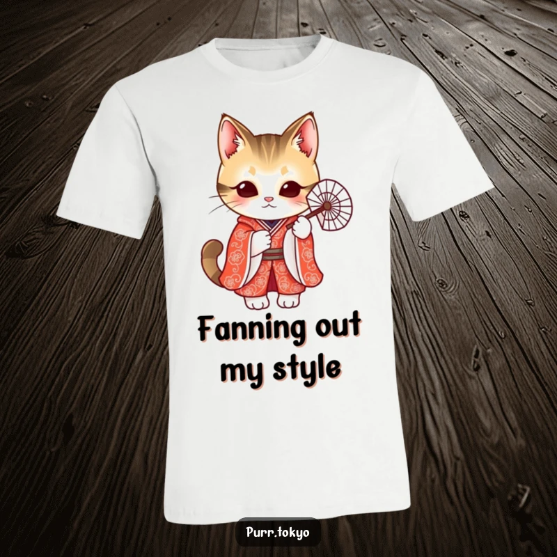 Funny t-shirt featuring an adorable cat dressed in a vibrant red kimono, holding a delicate fan with poise.